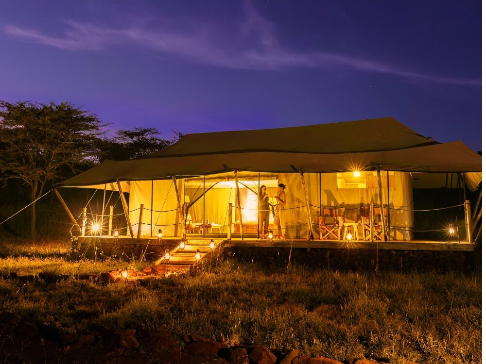Luxury tented camp lit at dusk
